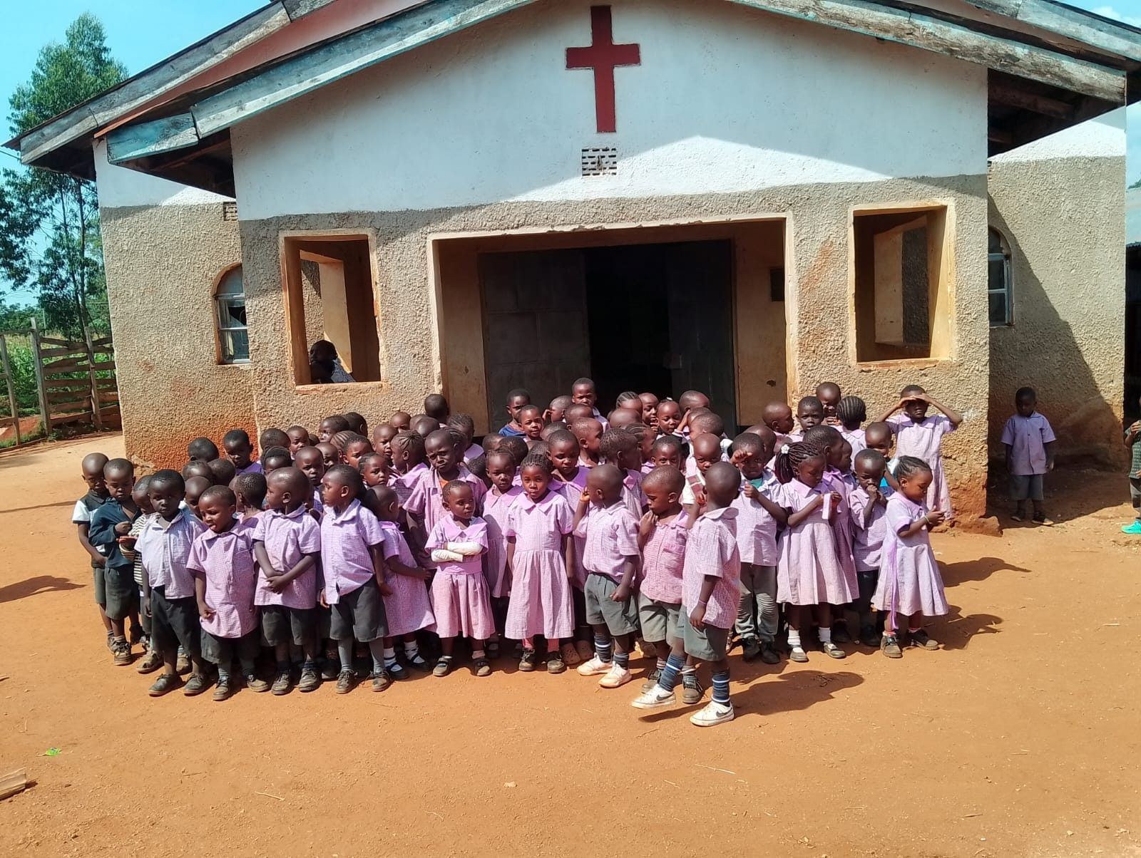 pupils in school uniform seated together for a group photo